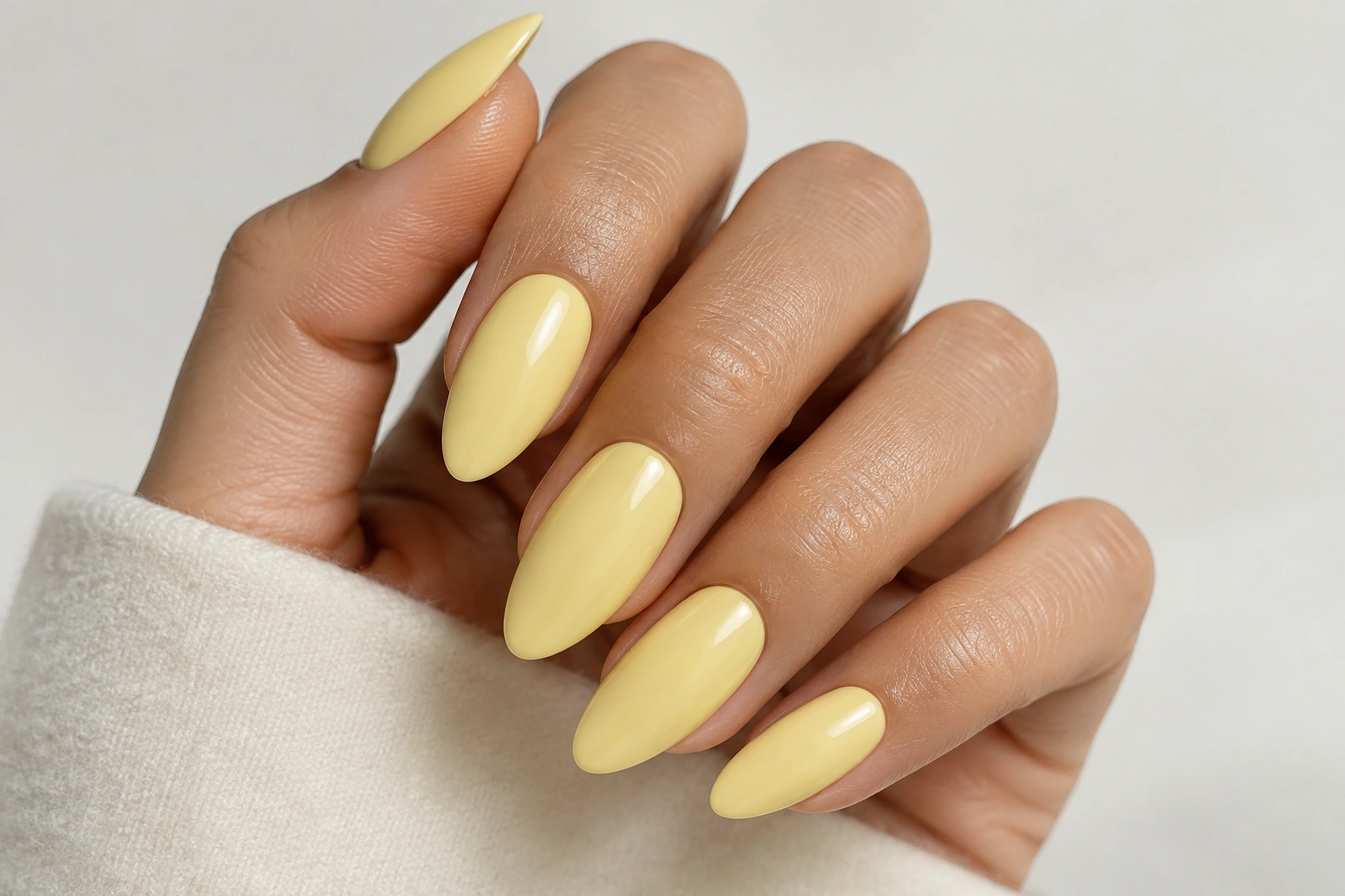 Butter yellow almond nails with a glossy finish