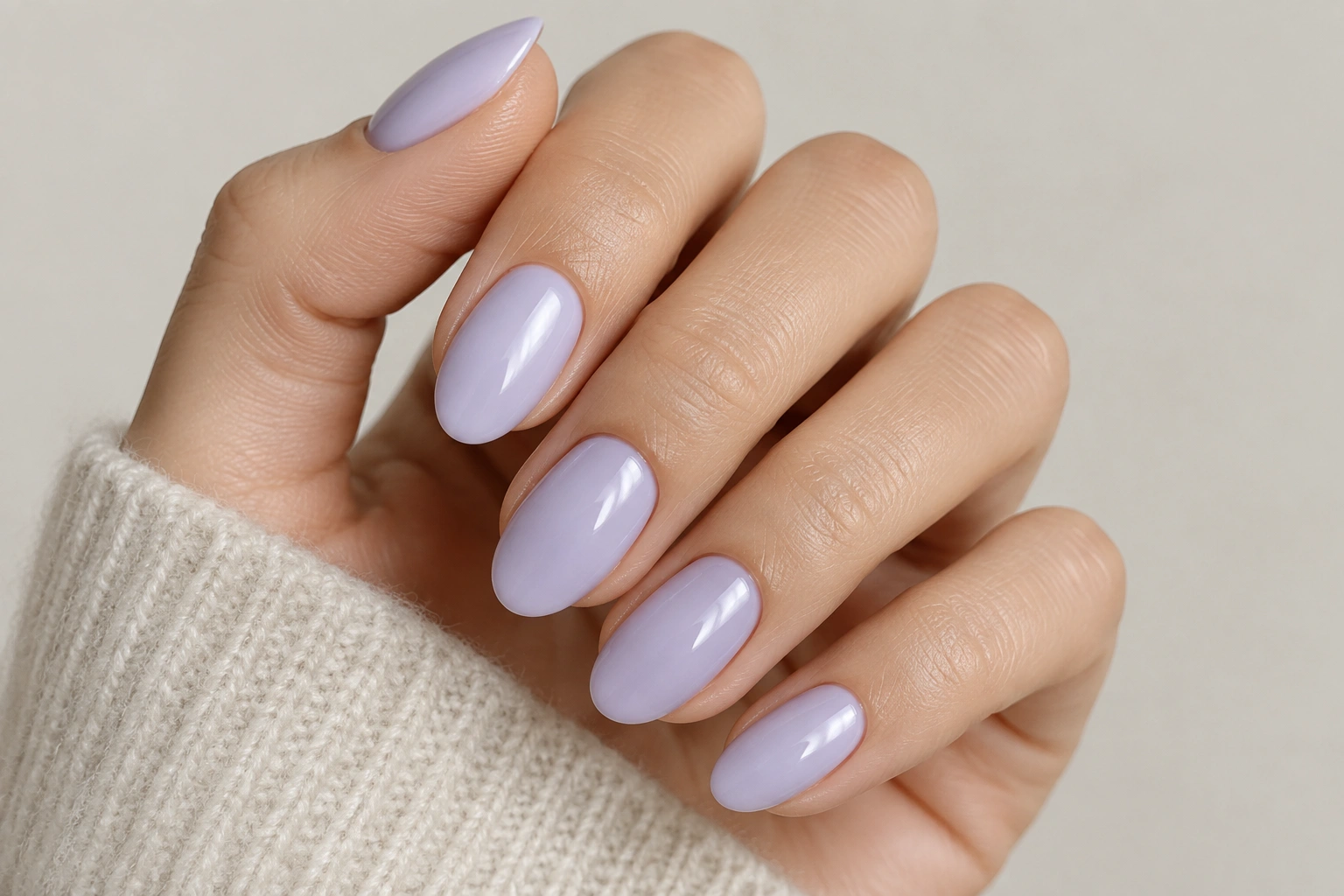 Milky lavender manicure with glossy finish on short almond nails