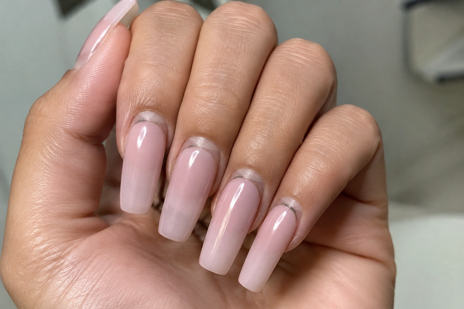Close-up of nail enhancement growth gap near the cuticle before a fill