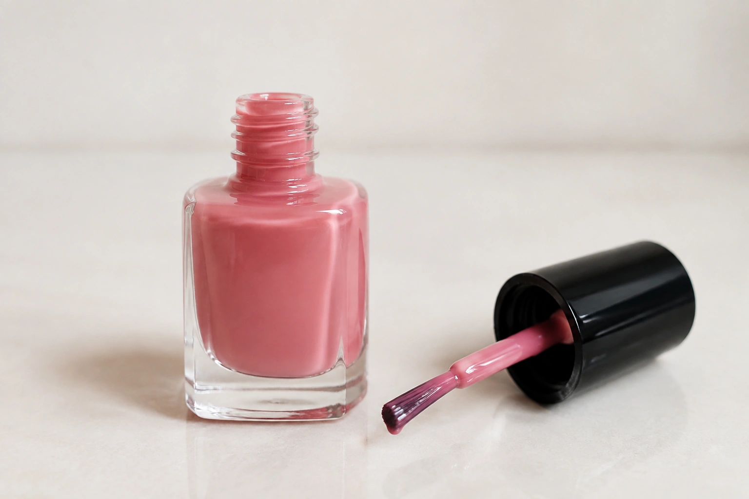 Opened nail polish bottle on a clean surface